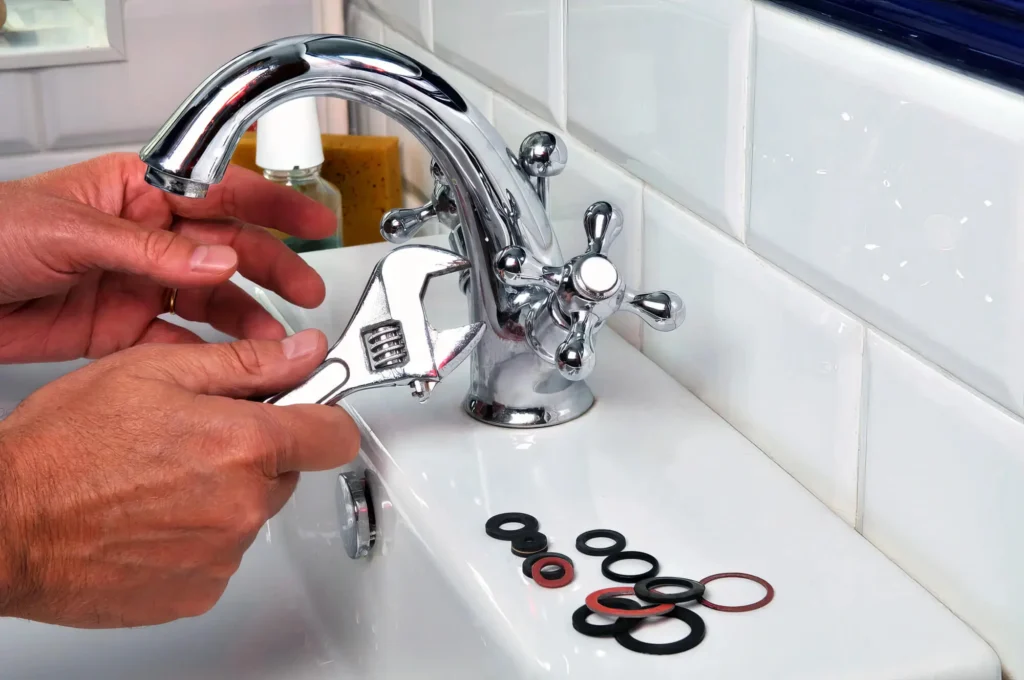 Plumber performing maintenance on a bathroom faucet in Lake Worth Beach