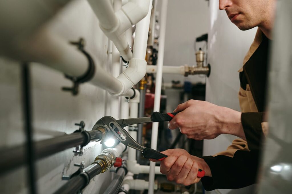 Plumbers maintaining commercial plumbing pipes in Lake Worth Beach