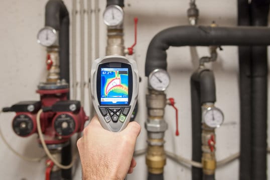 Plumber using a thermal imaging camera to inspect pipes in Lake Worth Beach