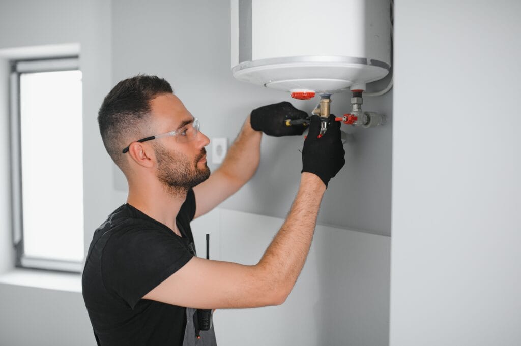 Technician performing water heater maintenance in Lake Worth Beach